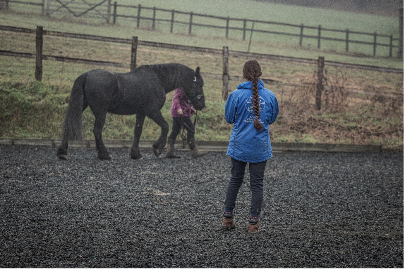 Girl Walking with Horse Led by Trainer