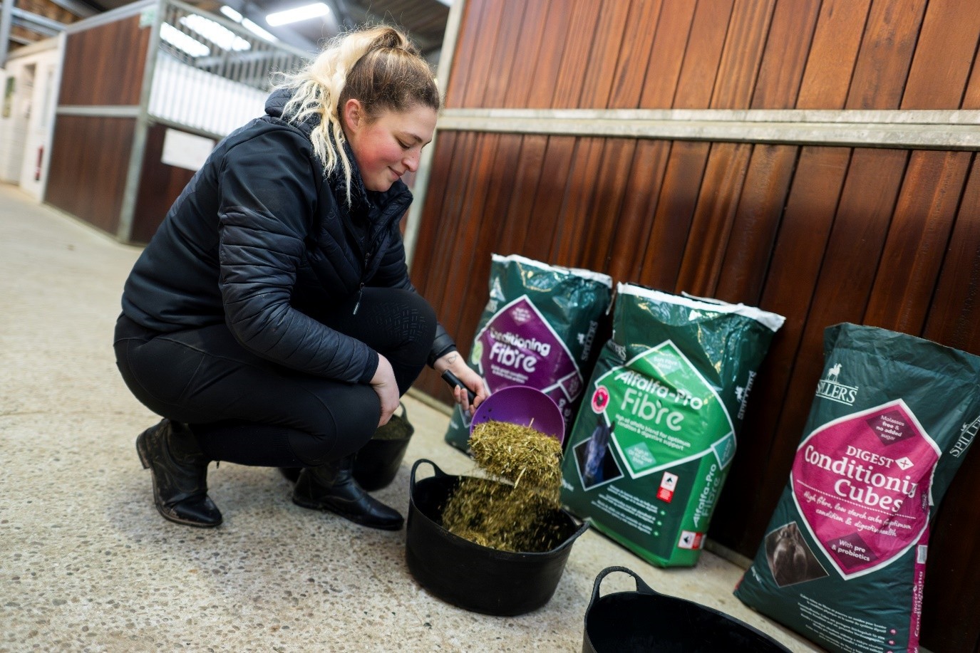 woman preparing horse feed with fibre